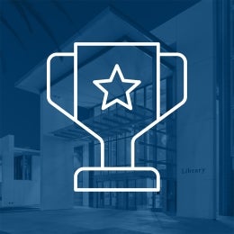 Trophy icon superimposed over a navy-tinted library photo