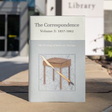 Copy of "Correspondence Volume 3" in front of UCSB Library's Paseo West entrance.